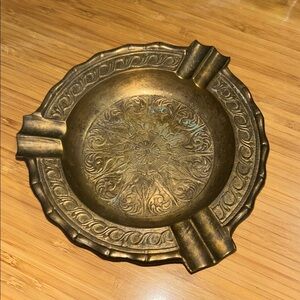 vintage antique brass ashtray, likely hand-engraved with a floral pattern